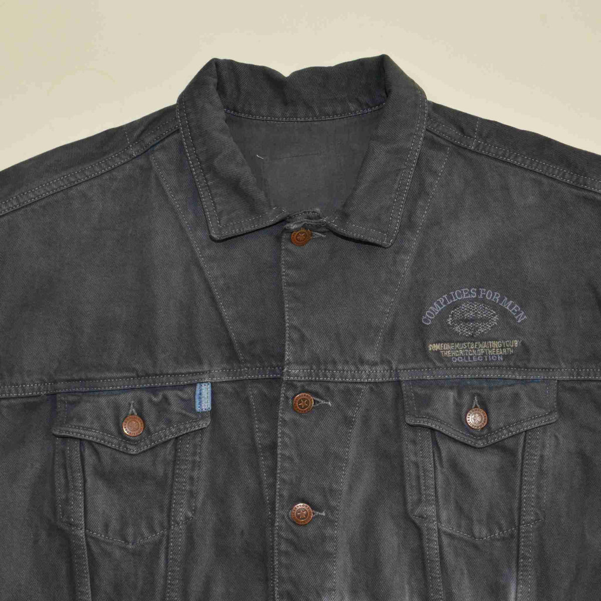 a black jacket with buttons on the back of it.