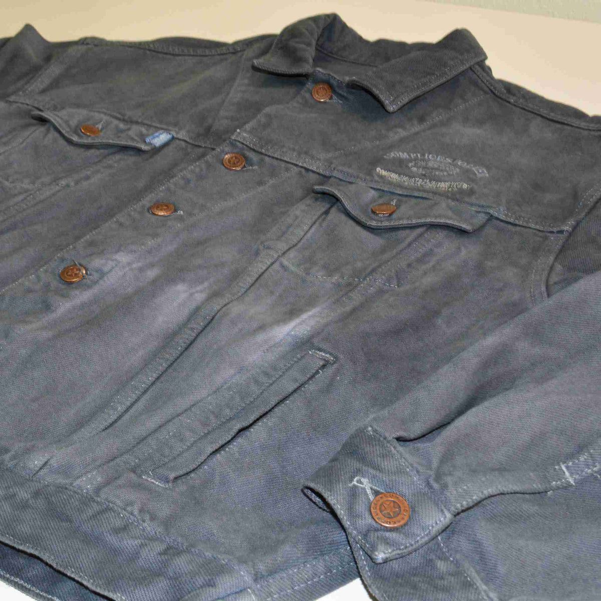 a pair of gray pants laying on top of a table.