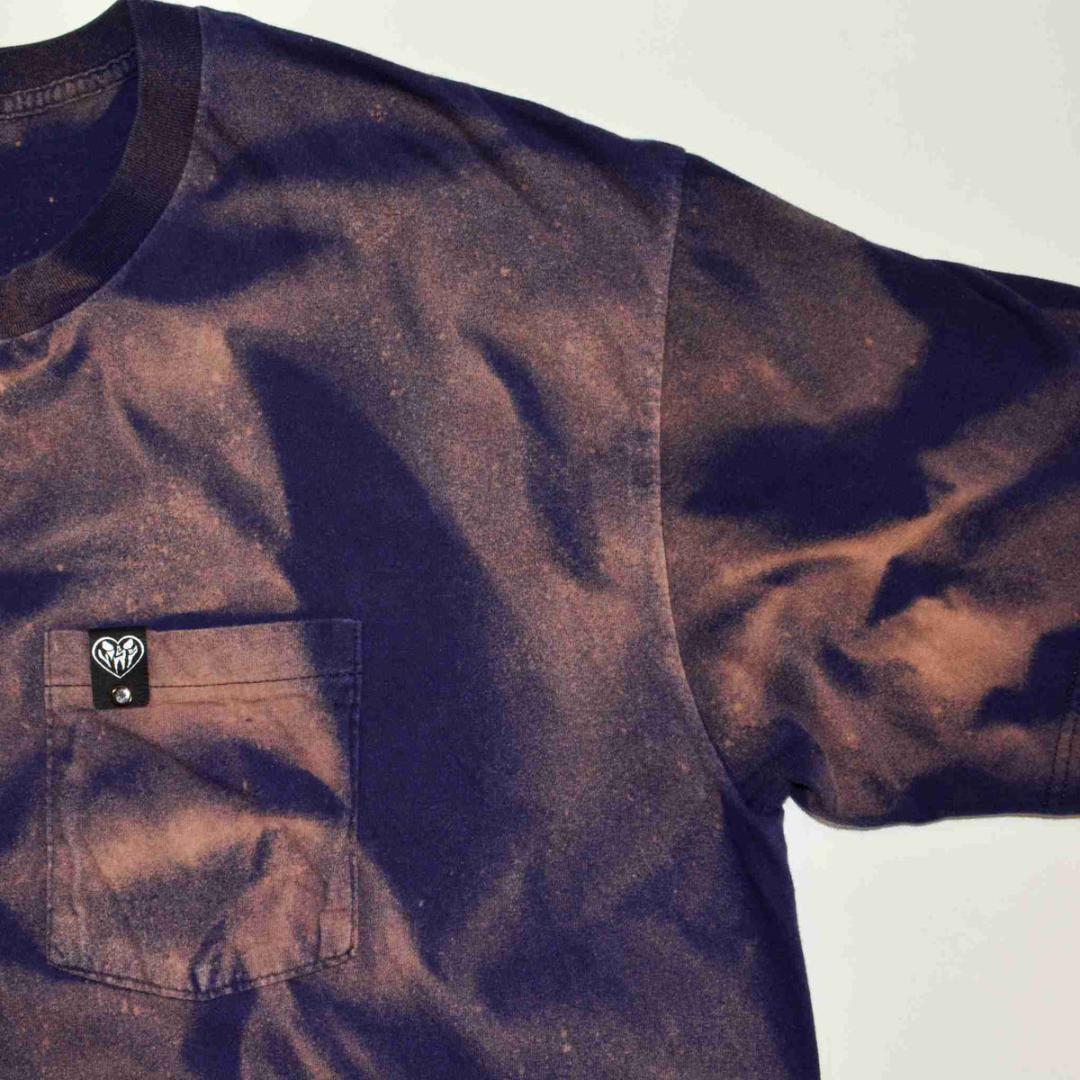 a tie dye shirt with a pocket on it.