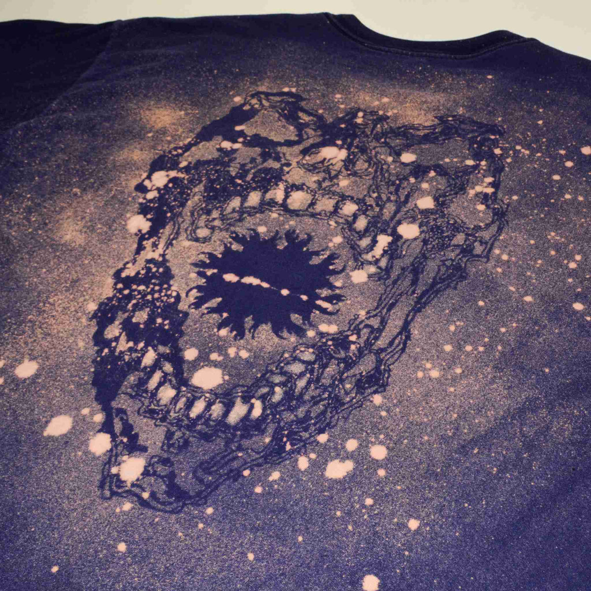 a t - shirt with a picture of a skull on it.