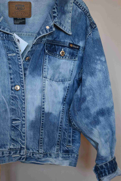 a blue jean jacket hanging on a wall.