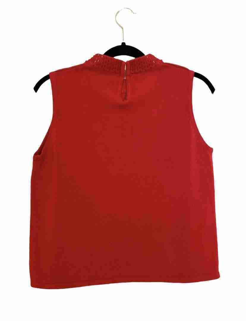 a red top hanging on a hanger.