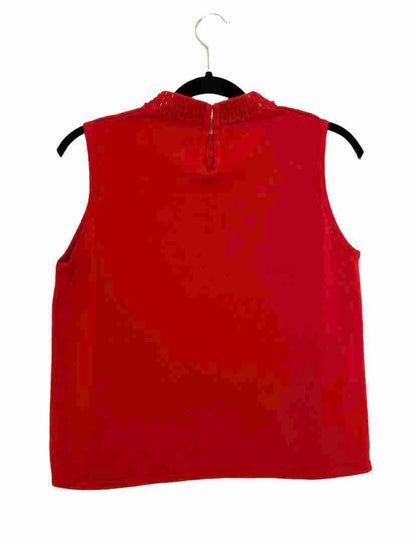 a red top hanging on a hanger.