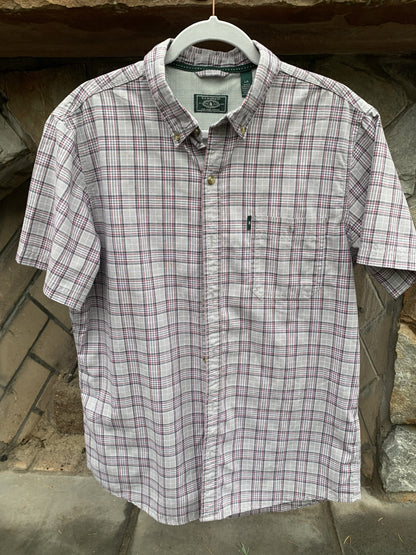 a plaid shirt hanging on a clothes line.
