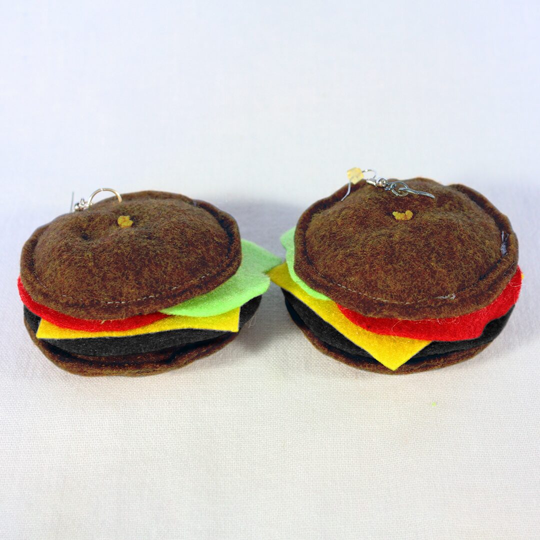 a couple of stuffed hamburgers sitting on top of a white table.