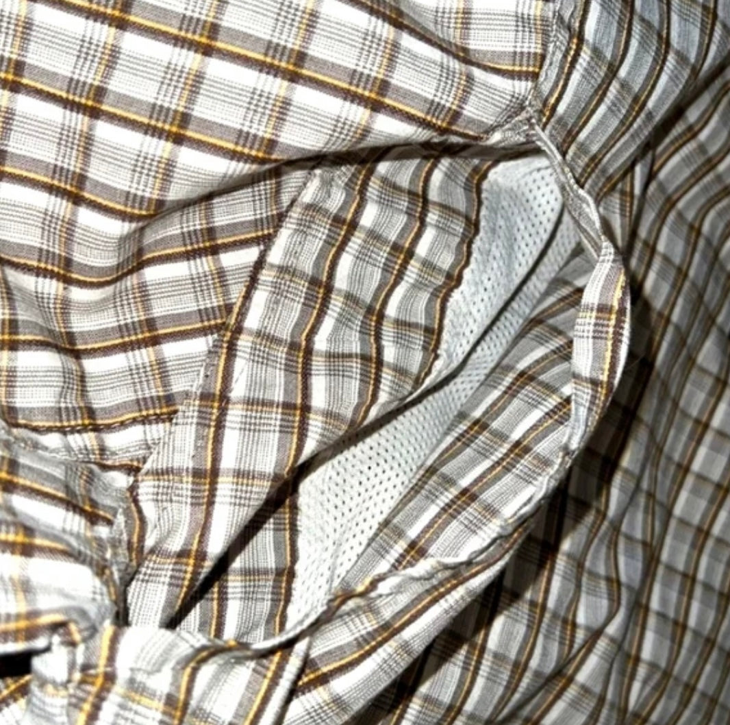 a close up of a shirt with a checkered pattern.