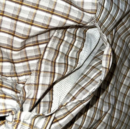 a close up of a shirt with a checkered pattern.