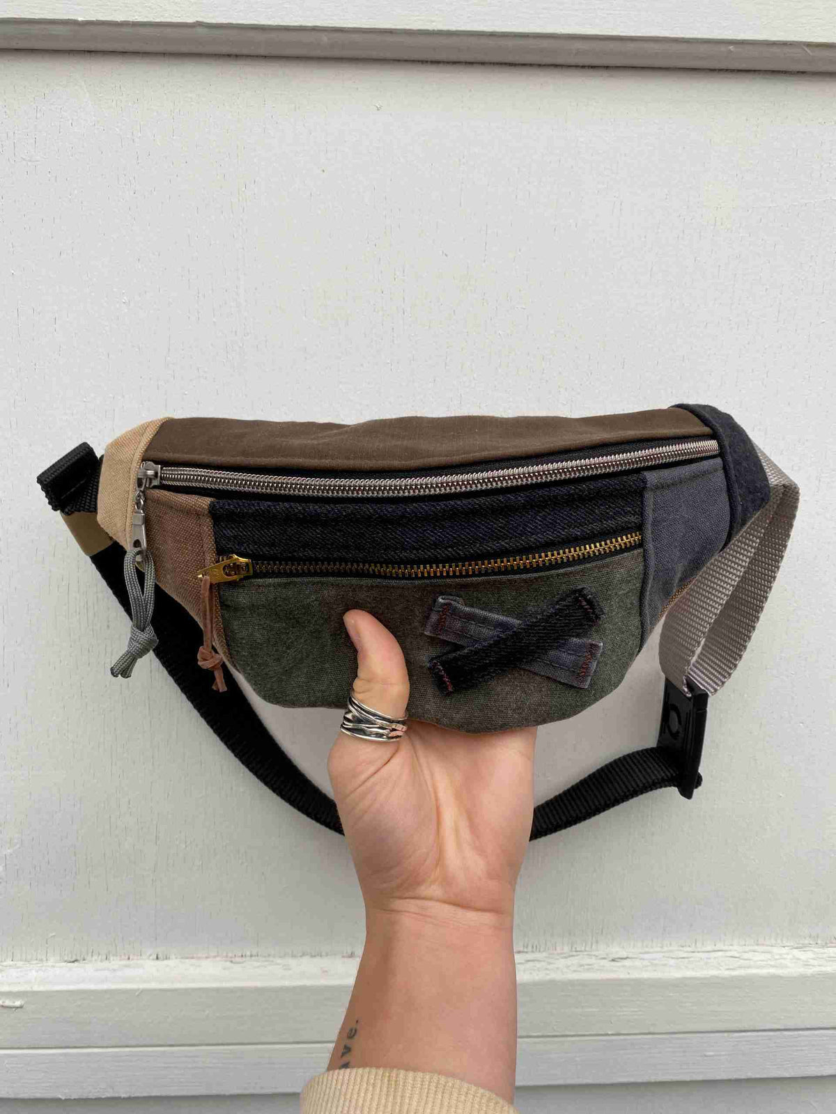 a person is holding a small purse in their hand.