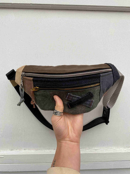 a person is holding a small purse in their hand.