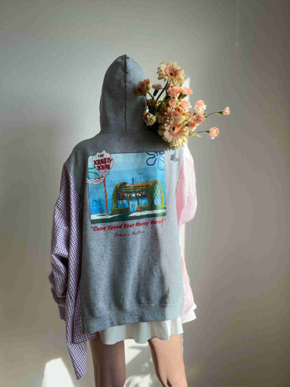 a person wearing a hoodie with flowers on their head.