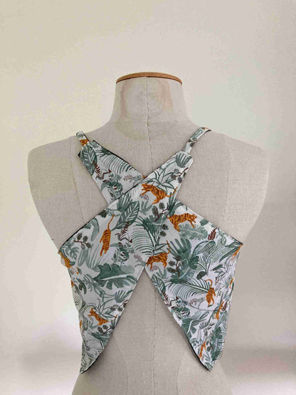 a white mannequin with a green and orange floral print on it.