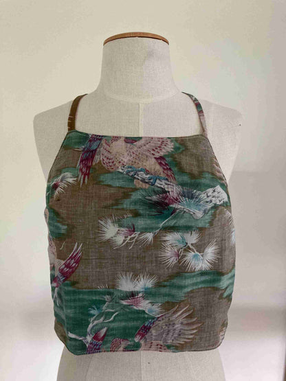 a mannequin wearing a brown and green top with birds on it.