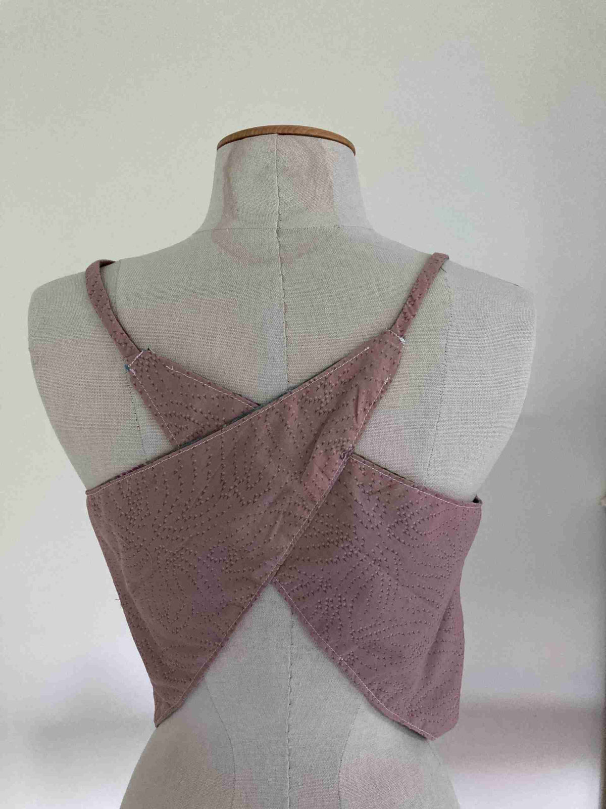 a white mannequin with a pink top on it.