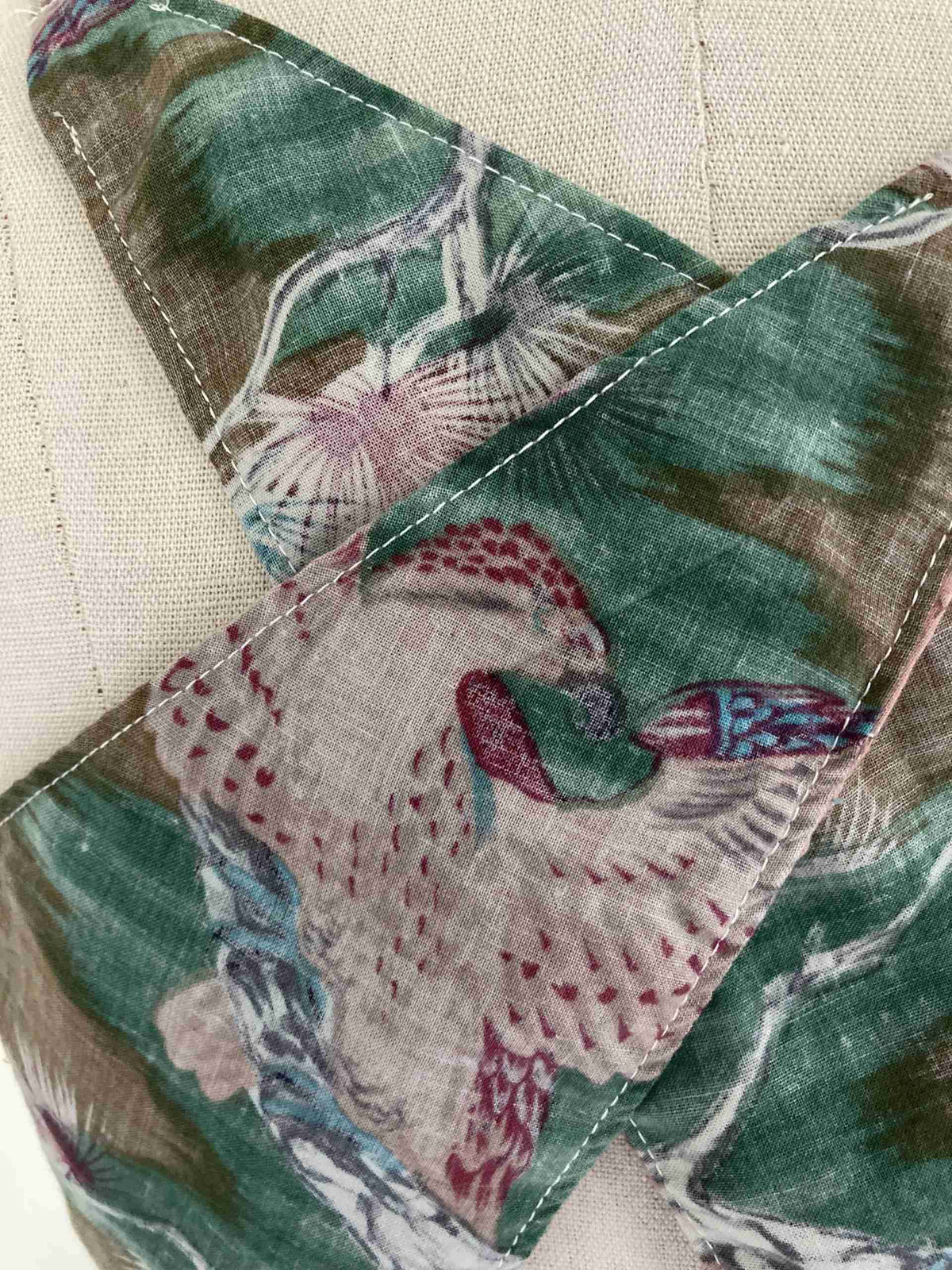 a close up of a tie with a bird on it.