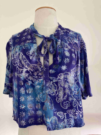 a mannequin wearing a blue shirt with a tie.