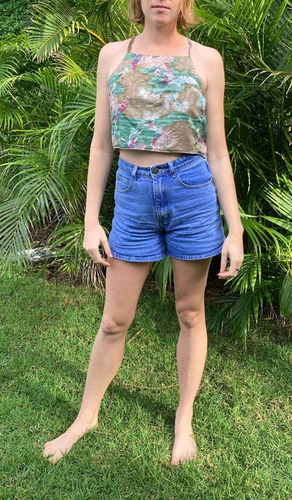 a woman standing in front of a bush.