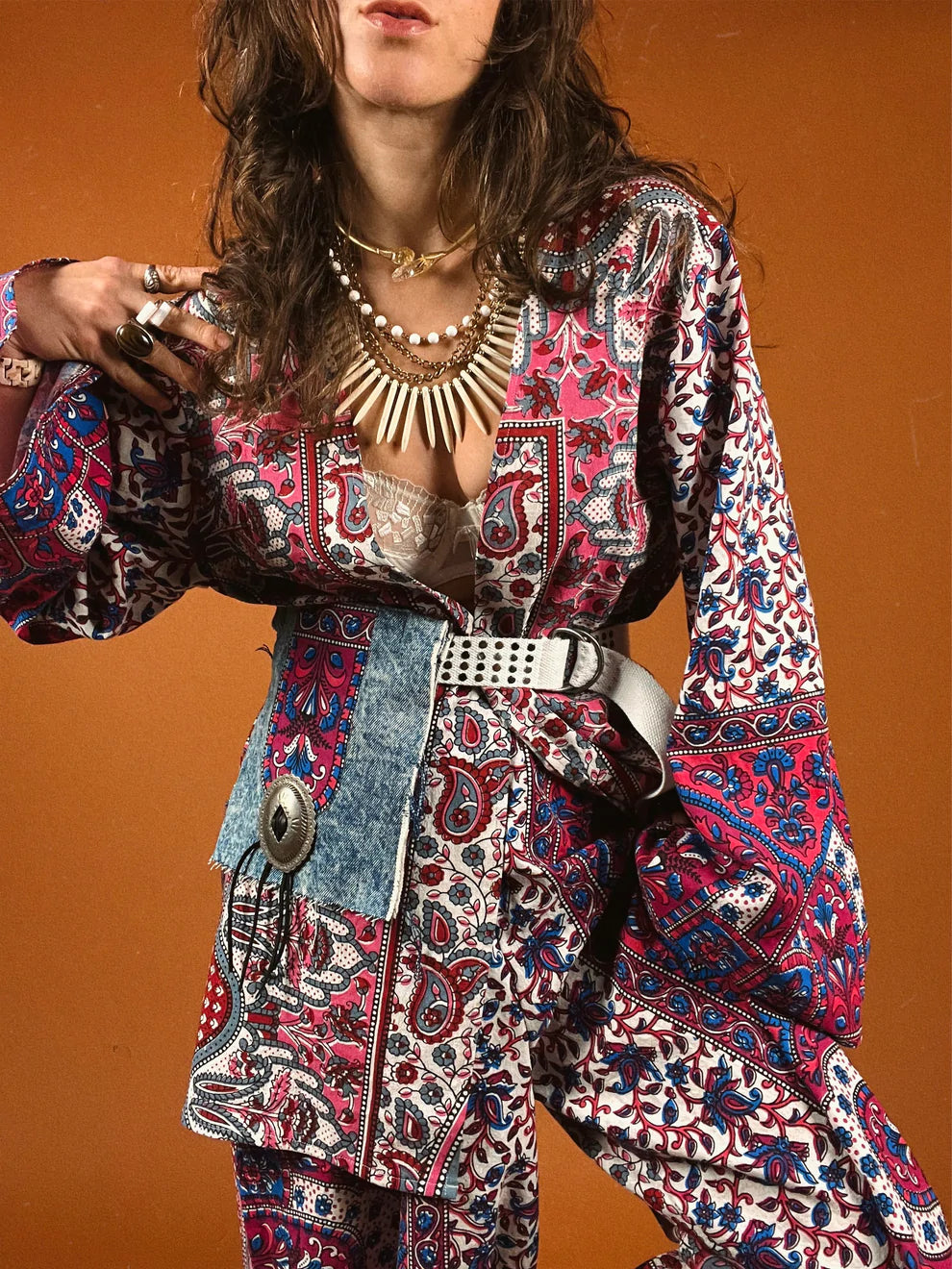 a woman in a colorful dress holding a camera.