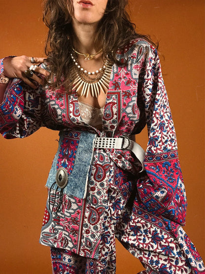 a woman in a colorful dress holding a camera.