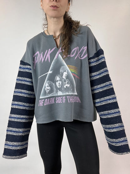 a woman with long hair wearing a pink floyd shirt.