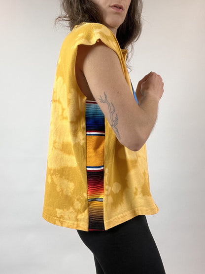 a woman wearing a yellow shirt and black pants.