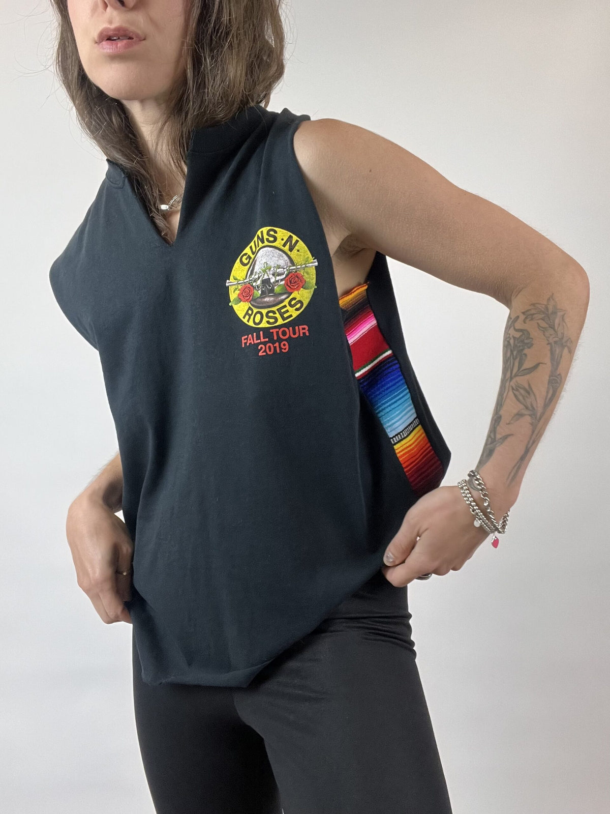 a woman wearing a black shirt with a rainbow ribbon around her neck.