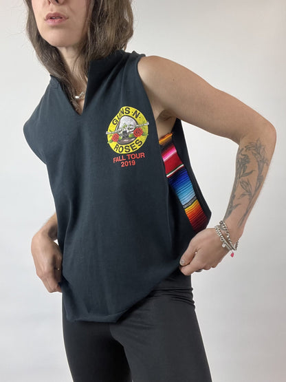 a woman wearing a black shirt with a rainbow ribbon around her neck.