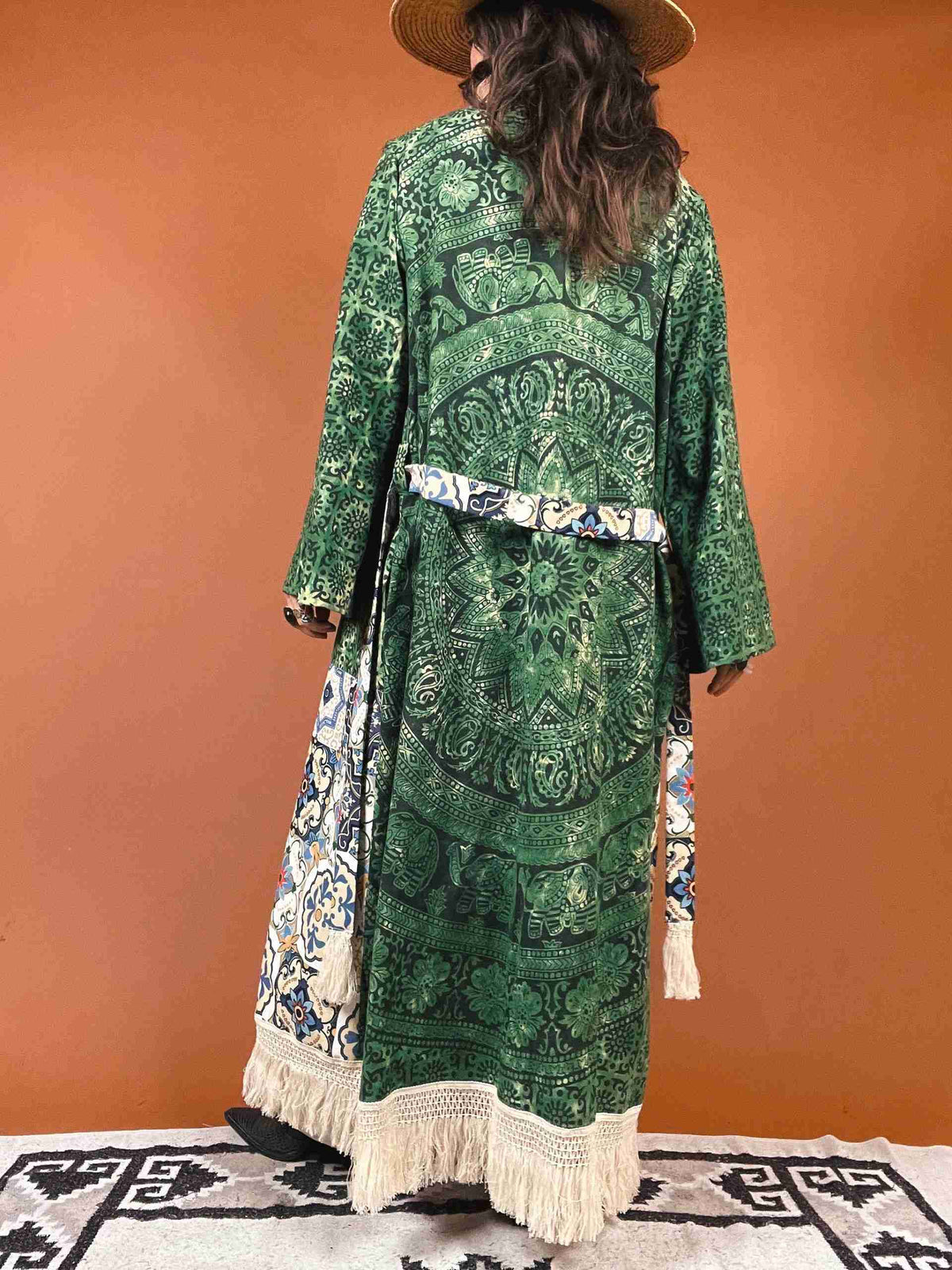 a woman wearing a green dress and hat.