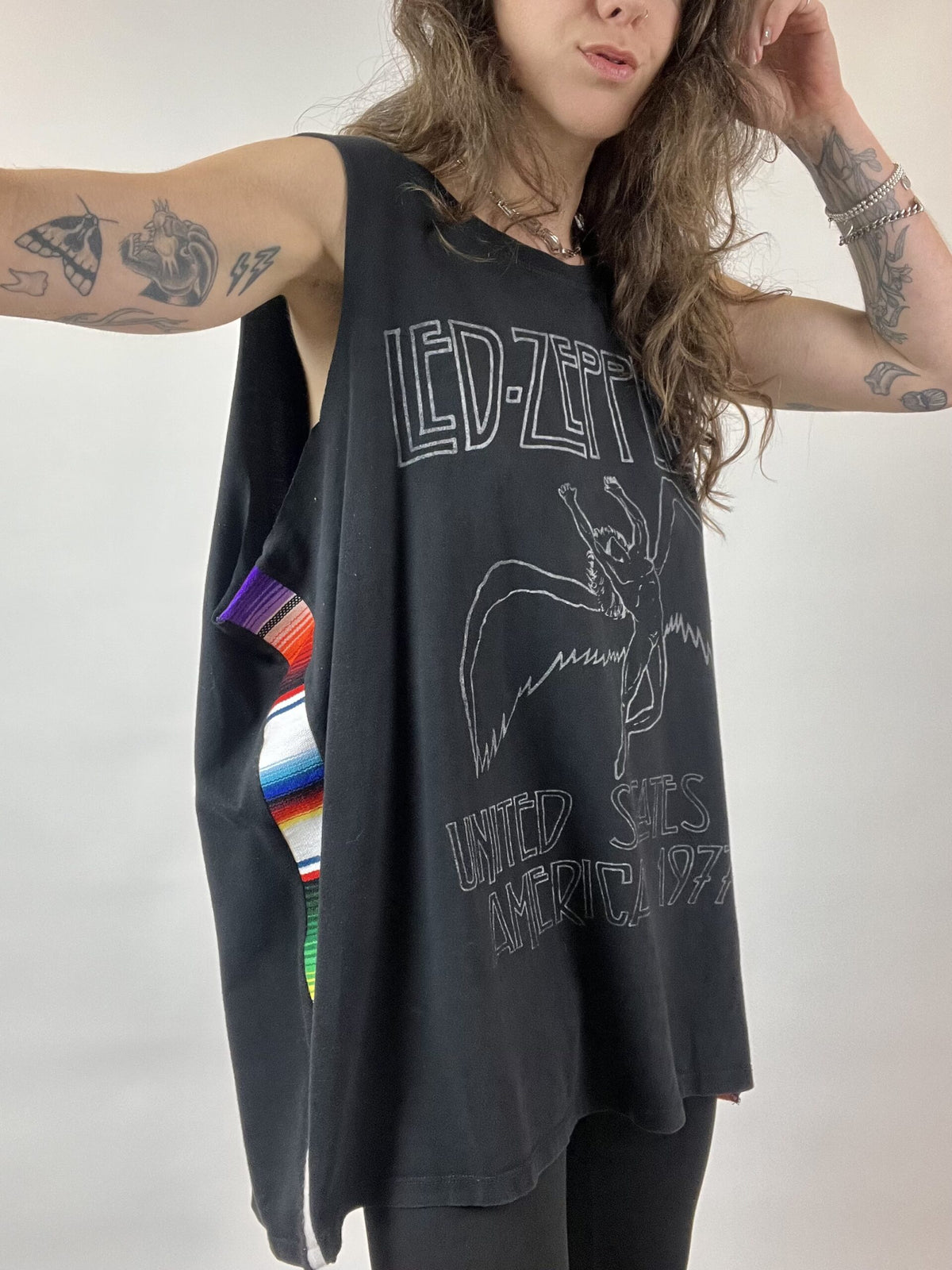 a woman with long hair wearing a tank top.