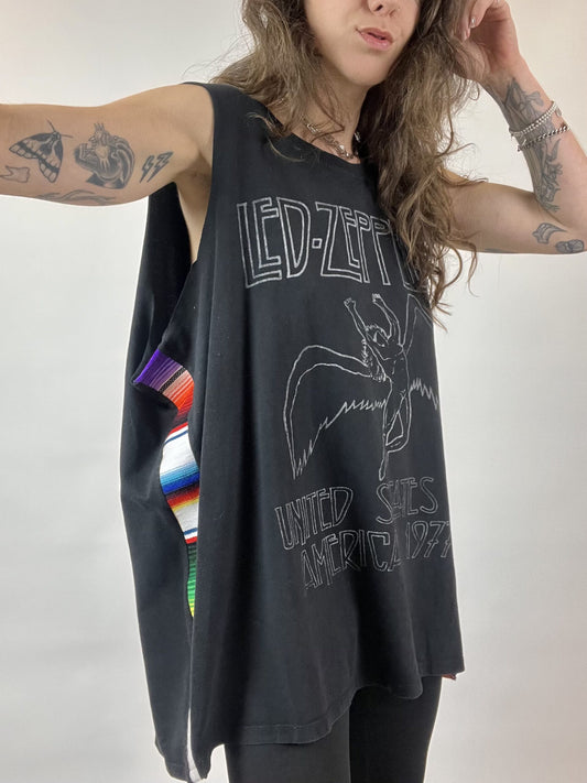 a woman with long hair wearing a tank top.