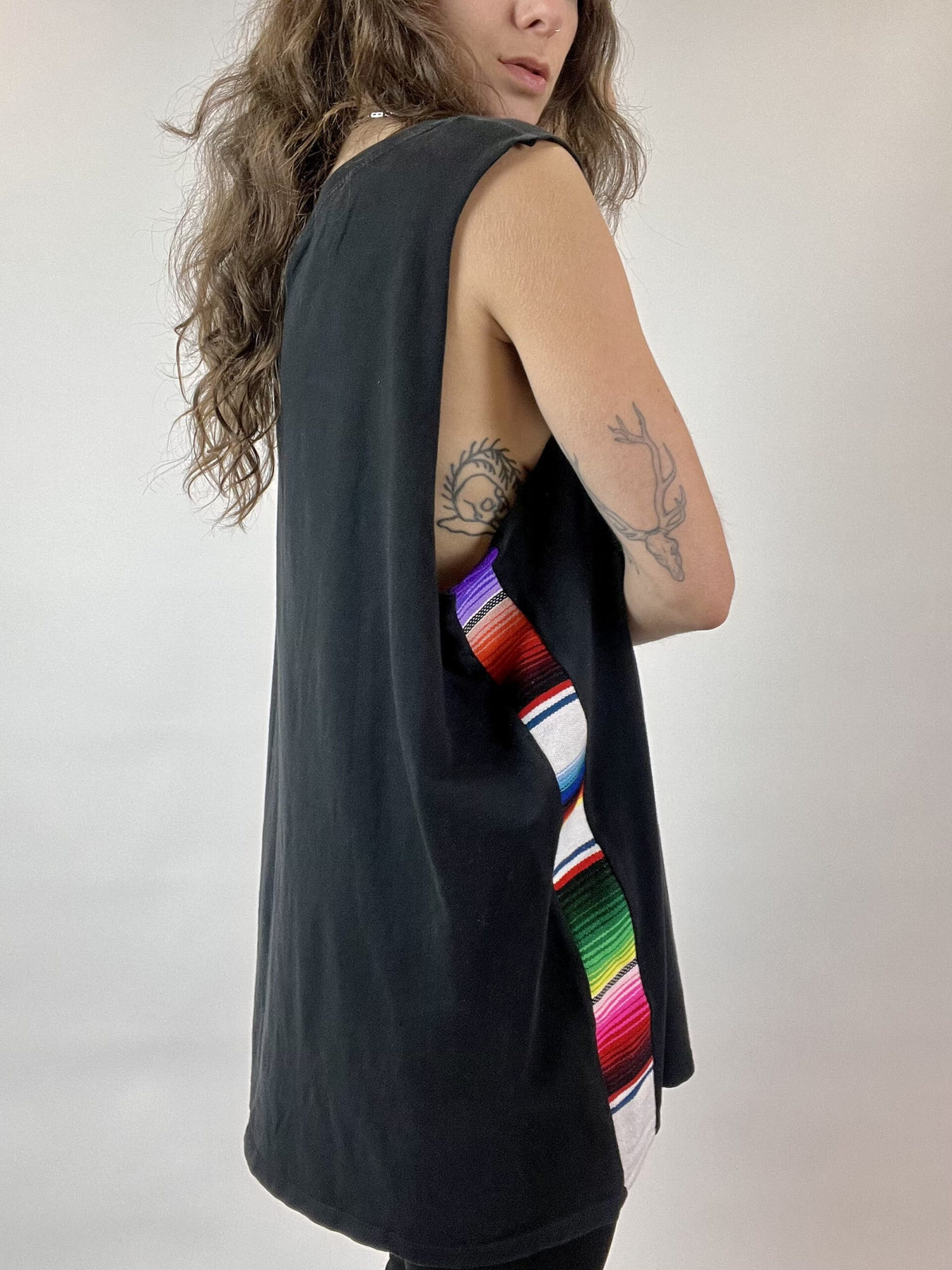 a woman with long hair wearing a black tank top.