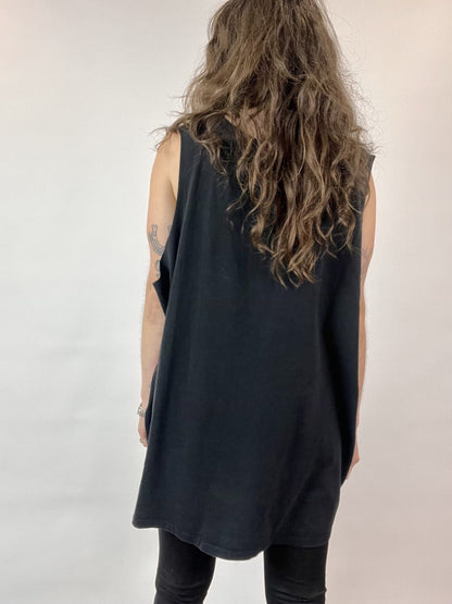 a woman with long hair wearing a black top.