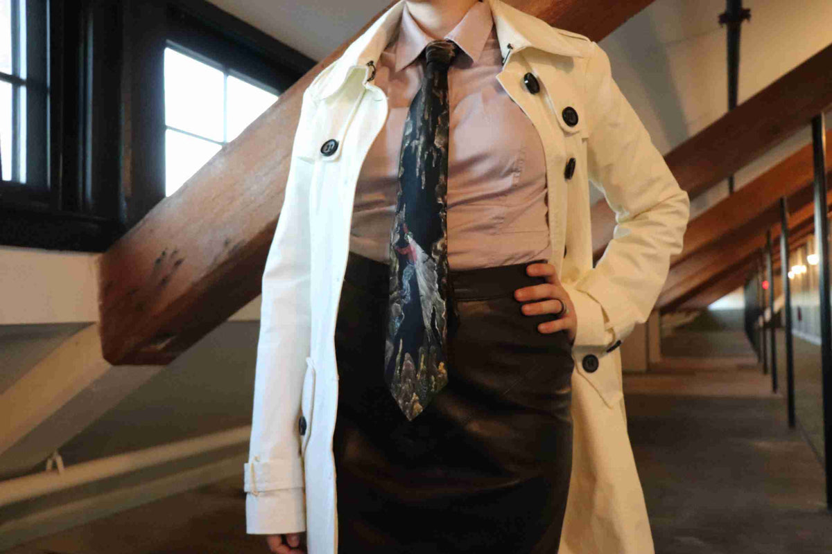a woman in a skirt and trench coat posing for a picture.