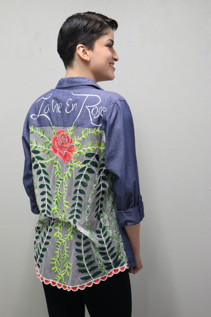 The back of a woman wearing a hand-painted shirt.