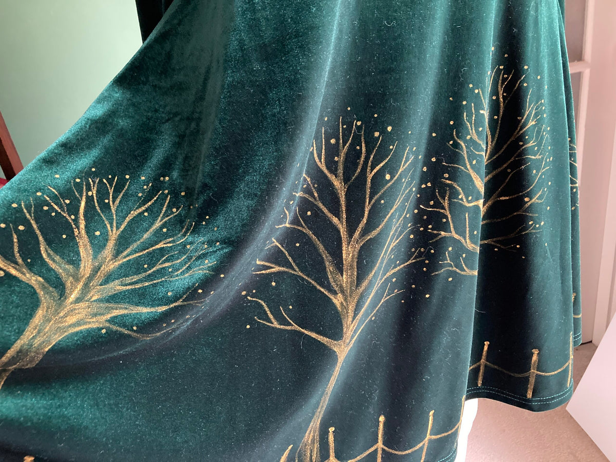 Bottom of green velvet dress with hand-painted gold trees