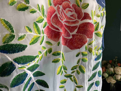 a close up of a flower on a curtain.