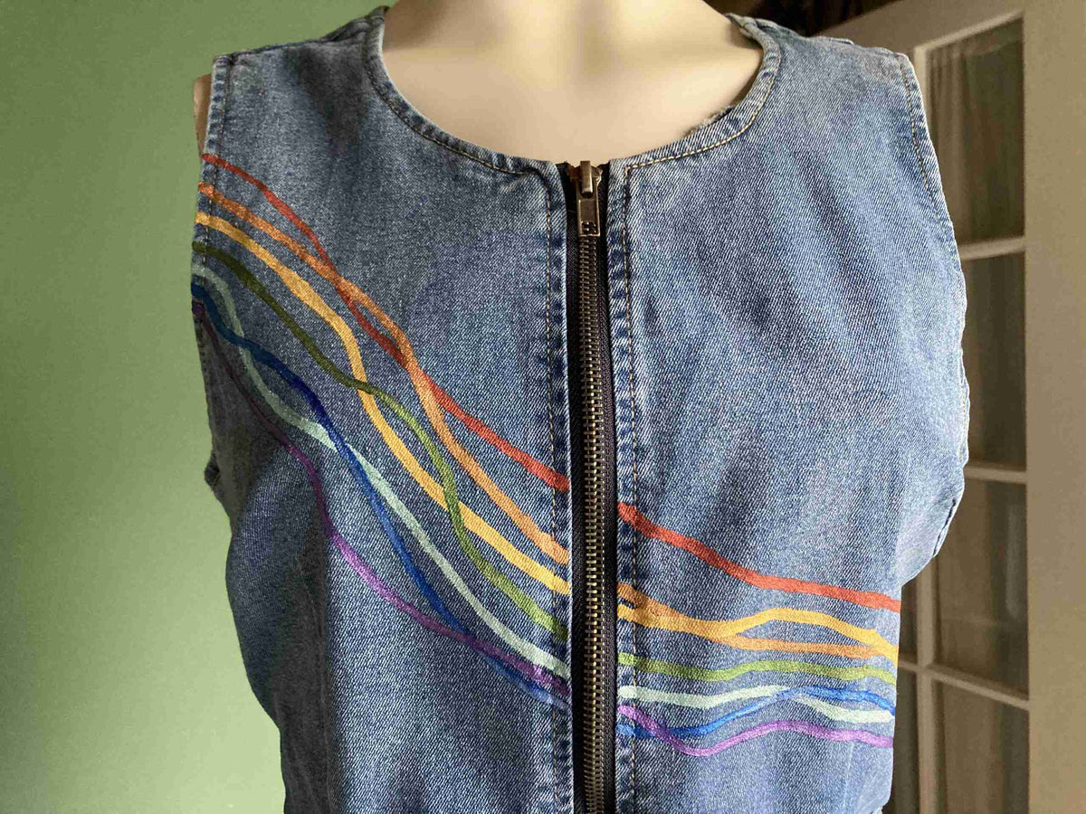 a denim dress with a zipper down the middle of it.