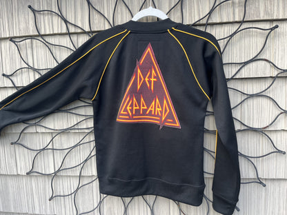 A black sweatshirt with an orange triangle on it.