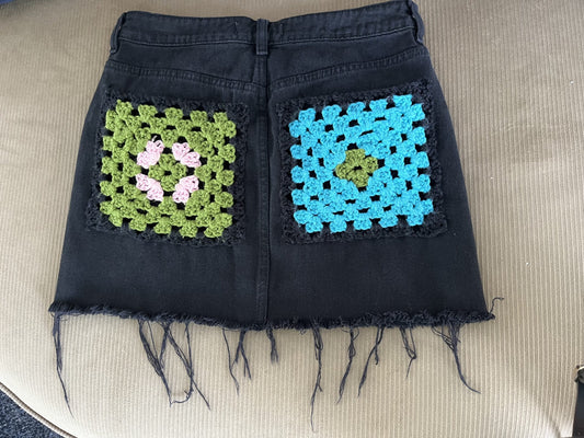 A black skirt with colorful squares on it.