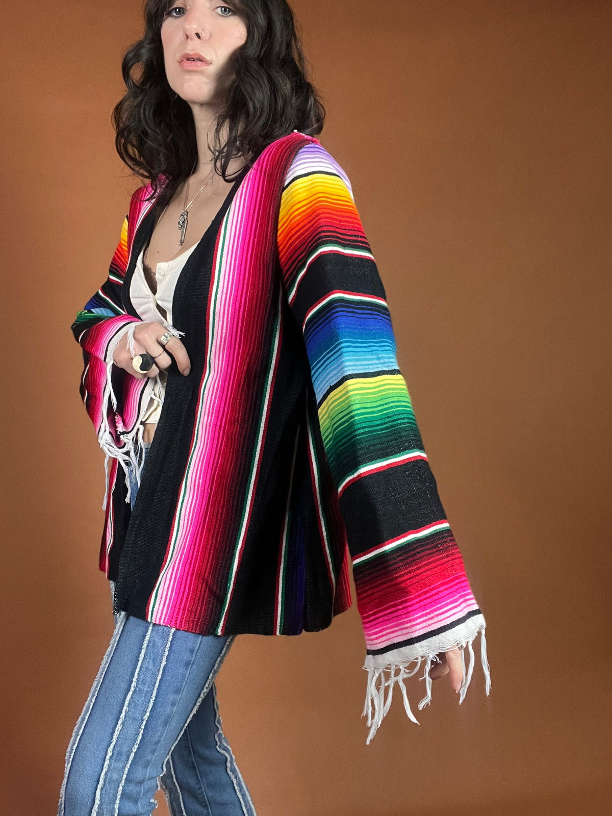 A woman wearing a colorful mexican cardigan.