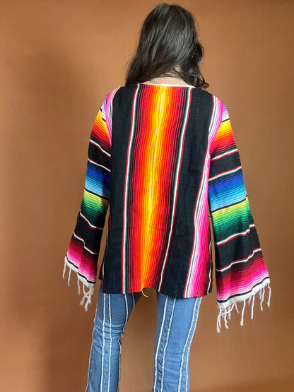 A woman wearing a colorful poncho.