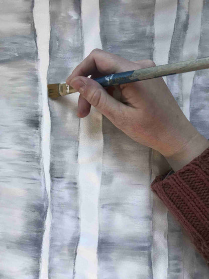 a person holding a paintbrush in their hand.
