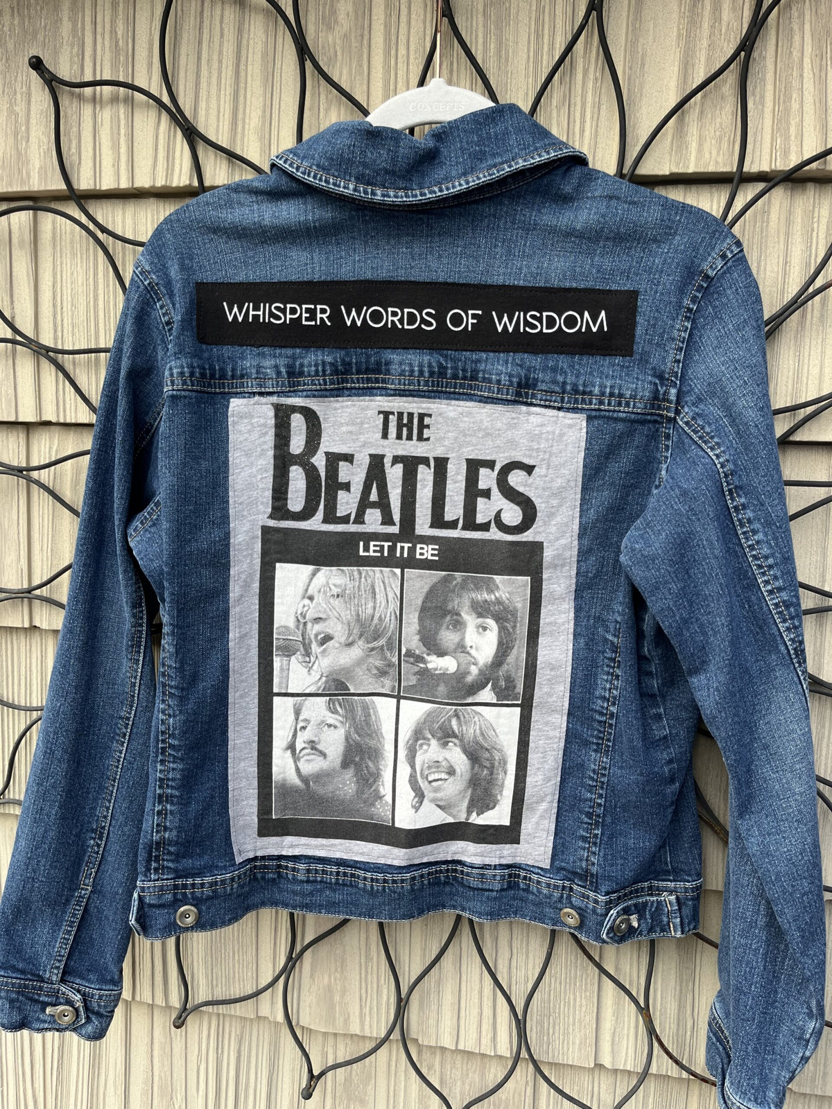 A denim jacket with the beatles on it.