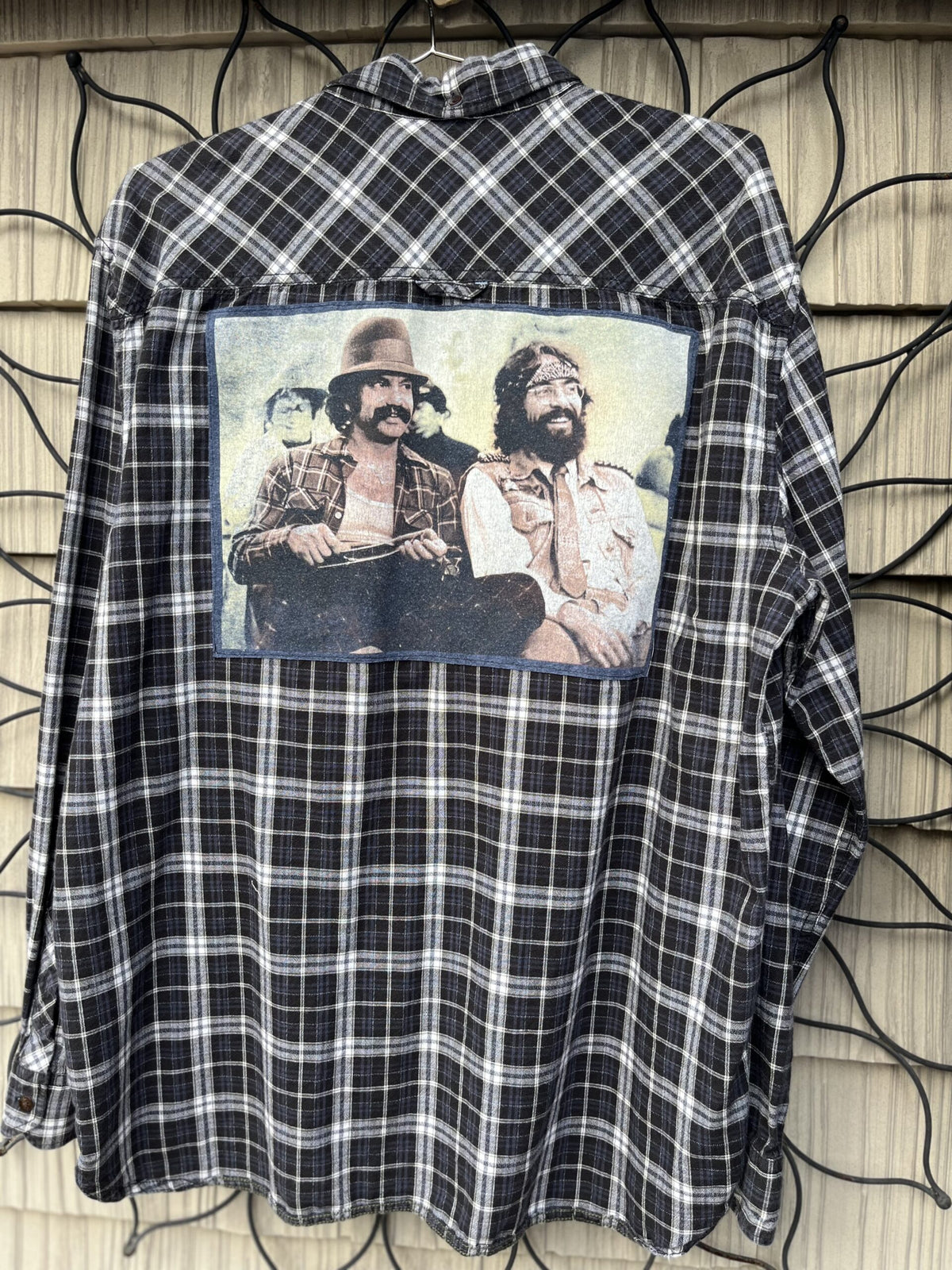 A flannel shirt with a picture of two men on it.