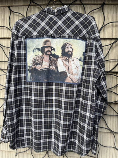 A flannel shirt with a picture of two men on it.