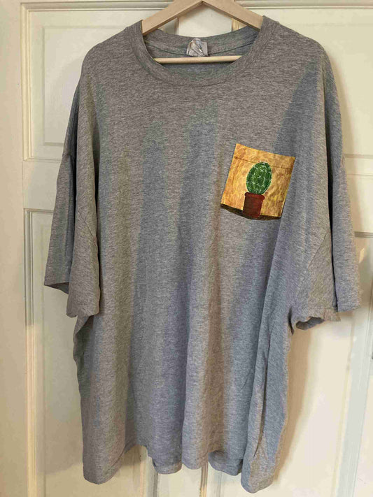 a gray shirt with a cactus pocket on it.
