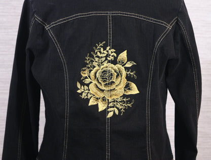 A black denim jacket with gold roses on the back.