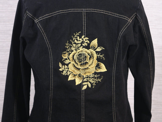 A black denim jacket with gold roses on the back.