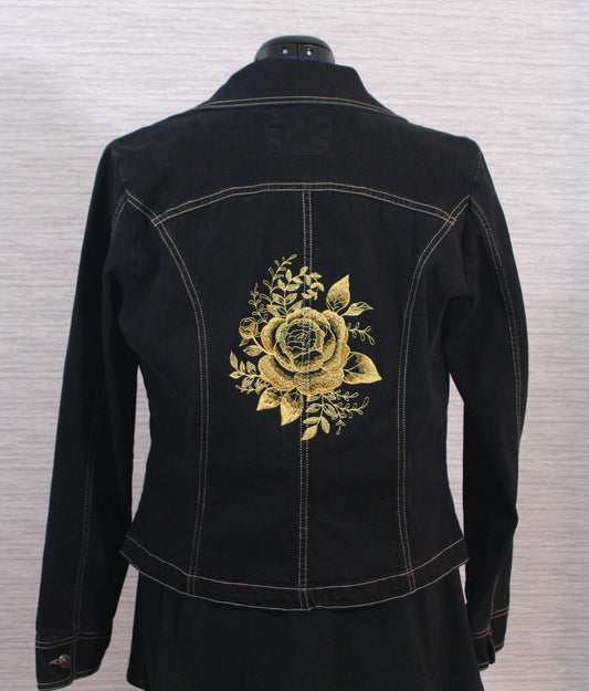 A black denim jacket with gold roses on the back.