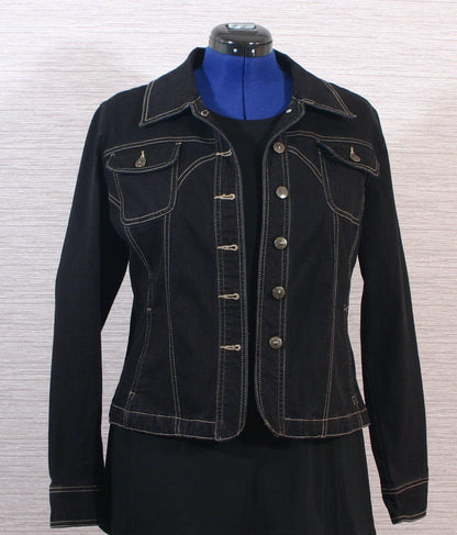 A black denim jacket on a mannequin dummy.