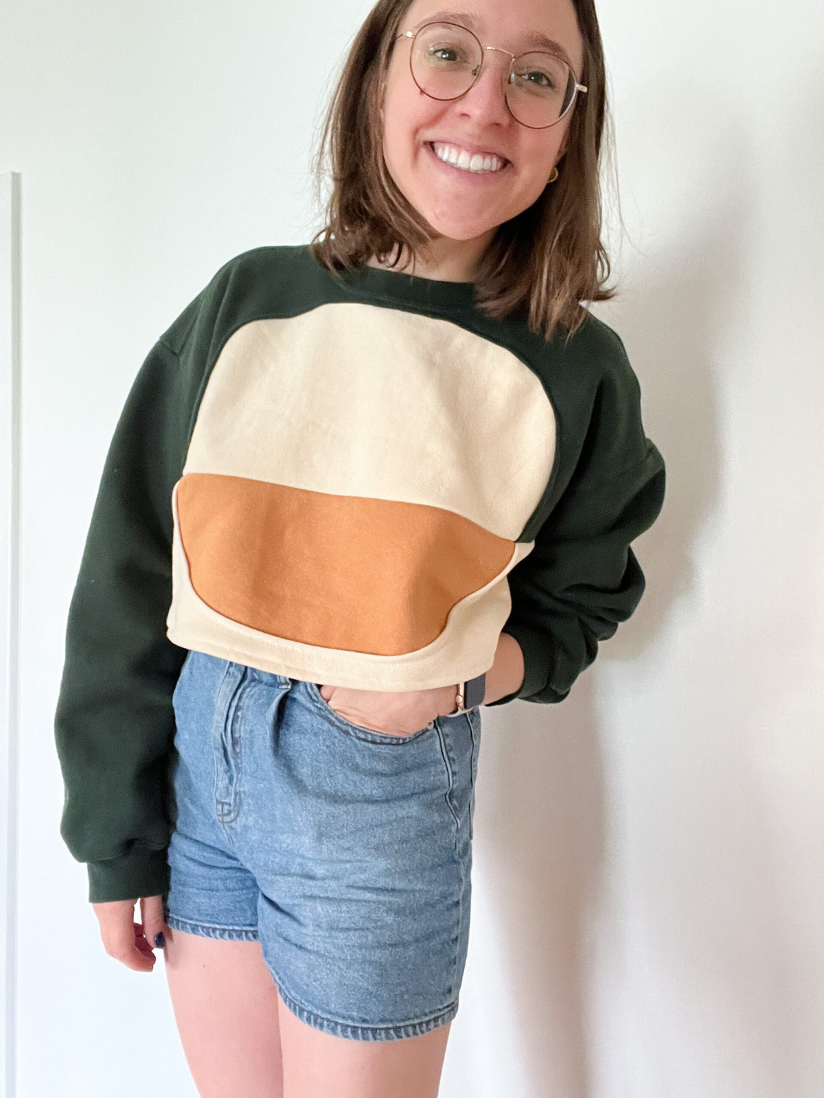 A woman wearing a Sweatshirt of the Year Block Cropped Sweatshirt with an ice cream sandwich on it.